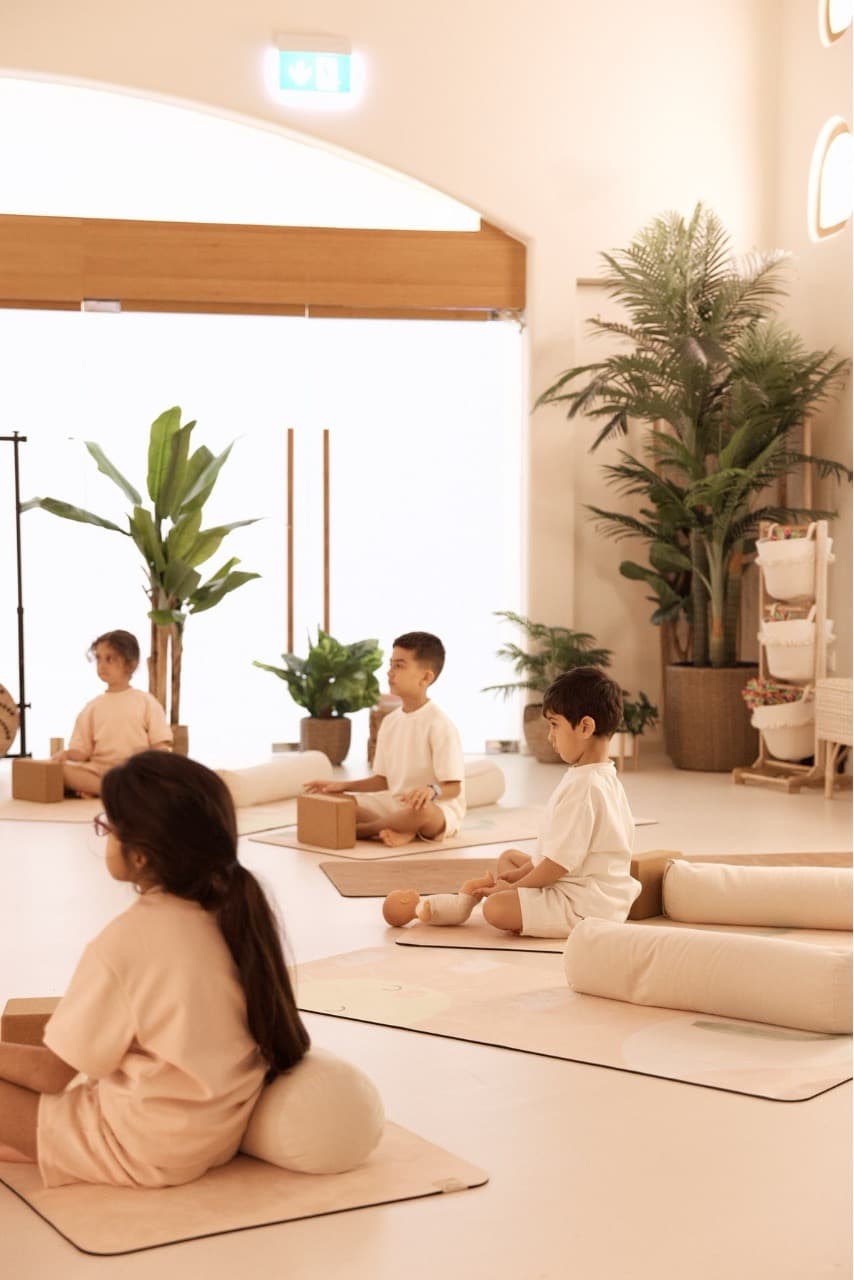 Children practicing yoga in a bright, modern studio